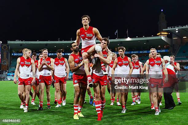 Kurt Tippett of the Swans is chaired from the field by team mates after the round 23 AFL match between the Sydney Swans and the Gold Coast Suns at...