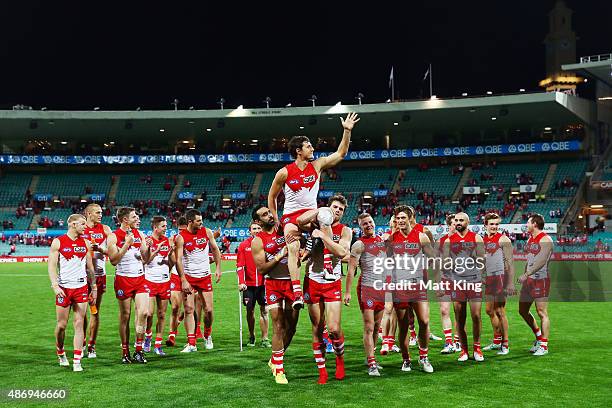 Kurt Tippett of the Swans is chaired from the field by team mates after the round 23 AFL match between the Sydney Swans and the Gold Coast Suns at...