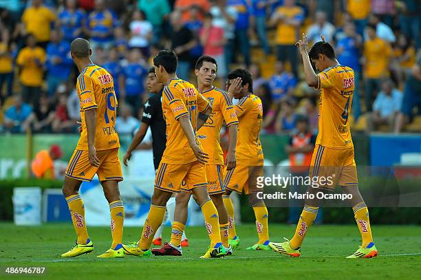 Hugo Ayala of Tigres celebrates with teammates after scoring the first goal of his team during a match between Tigres UANL and Atlas as part of 17th...