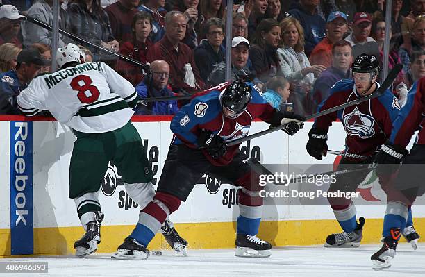 Cody McCormick of the Minnesota Wild and Jan Hejda of the Colorado Avalanche battle for control of the puck in Game Five of the First Round of the...