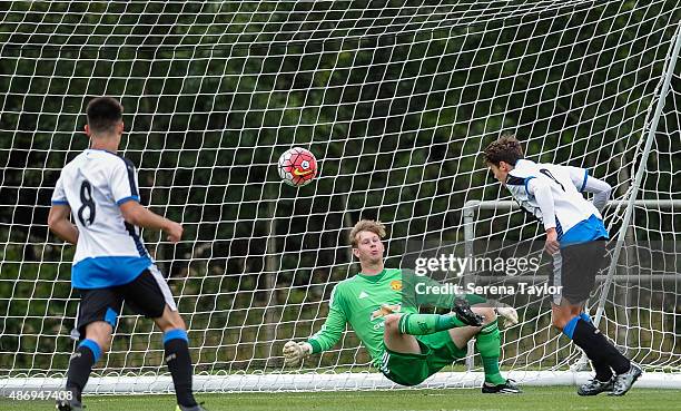 Lewis McNall of Newcastle heads the ball past Manchester goalkeeper George Dorrington to score the opening goal during the Under 18 Barclays Premier...