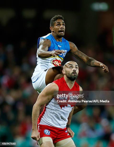 Jarrod Garlett of the Suns takes a mark under pressure from Rhyce Shaw of the Swans during the round 23 AFL match between the Sydney Swans and the...