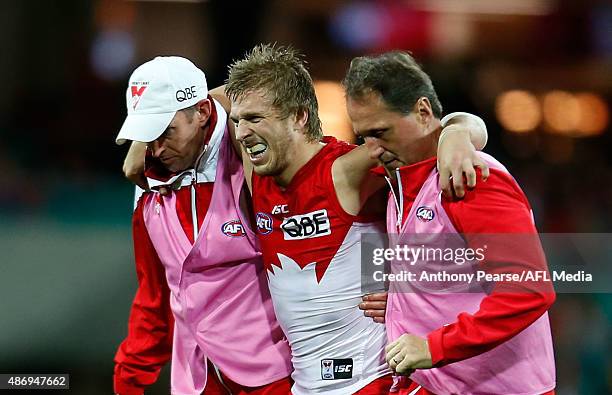 Kieren Jack of the Swans is helped from the field during the round 23 AFL match between the Sydney Swans and the Gold Coast Suns at Sydney Cricket...