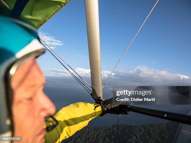 Man pilots an ultra light plane along the Annapurna mountain range in Nepal