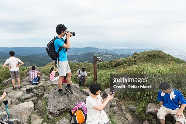 Group of people taking pictures on the top of the yangmingshan mountain in Taipei, Taiwan