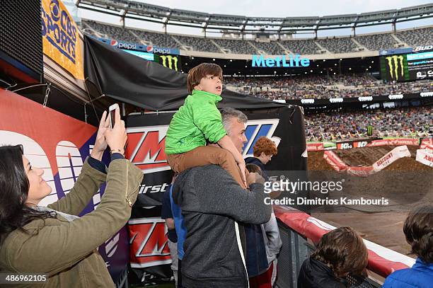 Shane McMahon of YOU on demand, formely WWE Pro Wrestler, watches the race while his wife Marissa Mazzola-McMahon takes a picture during Monster...