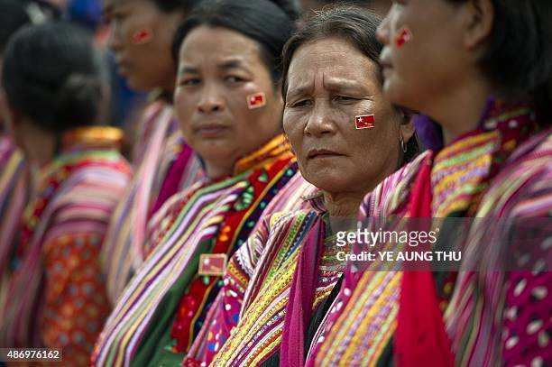 Ethnic old women wait for the arrival of National League for Democracy chairperson, Aung San Suu Kyi during a voter education campaign at the Hsiseng...