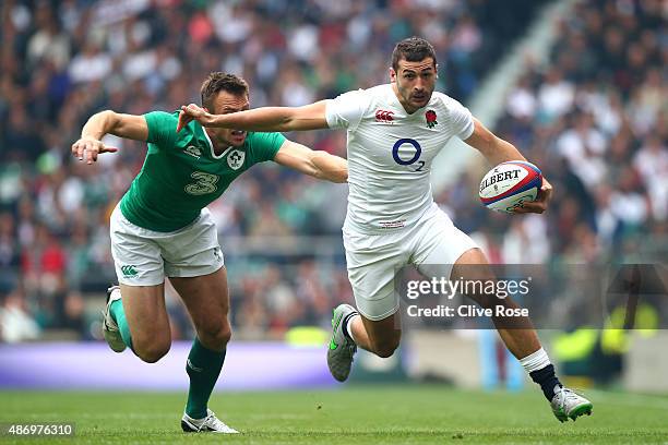 Jonny May of England hands off Tommy Bowe of Ireland during the QBE International match between England and Ireland at Twickenham Stadium on...