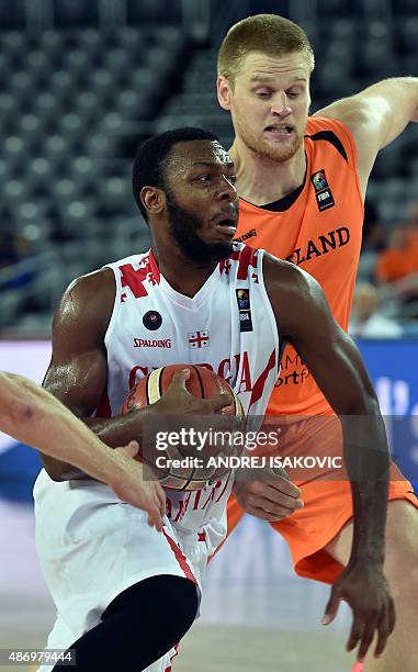 Georgia's guard Jacob Pullen vies with Netherlands' forward Roeland Schaftenaar during the Group C qualification basketball match between Georgia and...