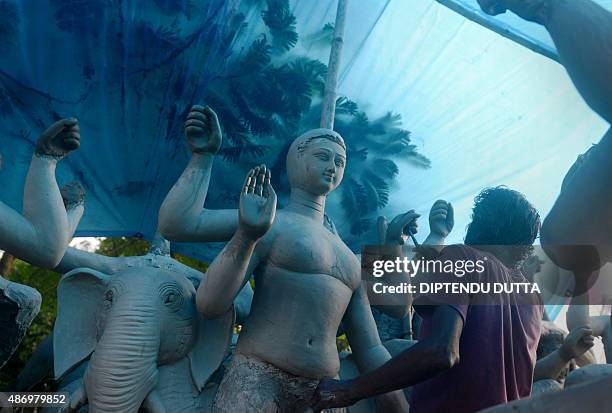 An Indian artisan makes a clay idol of the Hindu god of architecture, Biswakarma at his Kumortuli workshop in Siliguri on September 5, 2015. AFP...