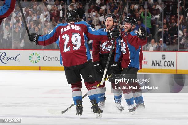 Parenteau of the Colorado Avalanche celebrates his tying goal late in the third period with teammates Nathan MacKinnon and Andre Benoit against the...