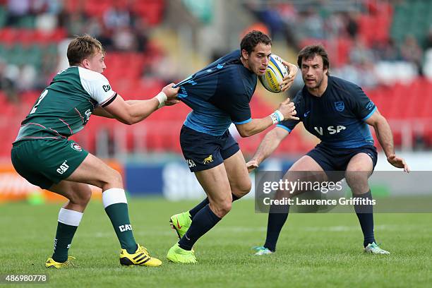 Joaquin Tuculet of Argentina is tackled by George Catchpole of Leicester Tigers during the Testimonial Challenge match between Leicester Tigers and...