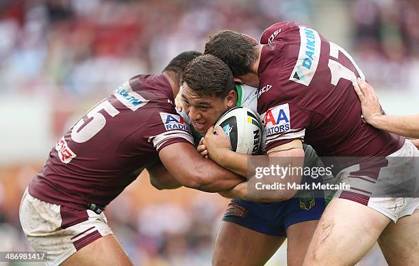 Josh Papalii of the Raiders is tackled by Dunamis Lui and Jason King of the Sea Eagles during the round 8 NRL match between the Manly-Warringah Sea...