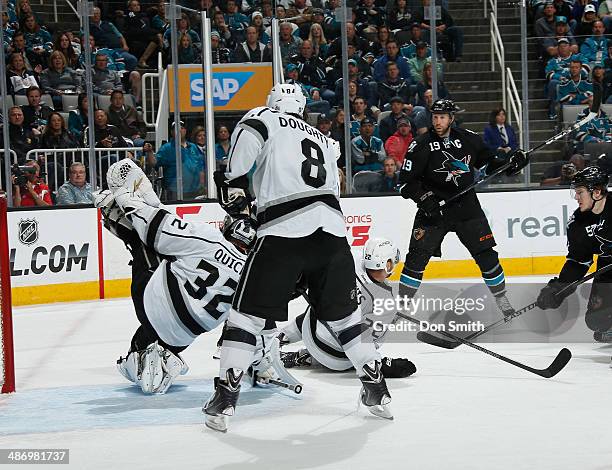 Jonathan Quick and Drew Doughty of the Los Angeles Kings protects the net against Joe Thornton of the San Jose Sharks in Game Five of the First Round...