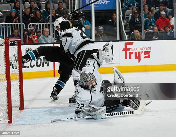 Logan Couture of the San Jose Sharks battles for position against Jarret Stoll and Jonathan Quick of the Los Angeles Kings in Game Five of the First...