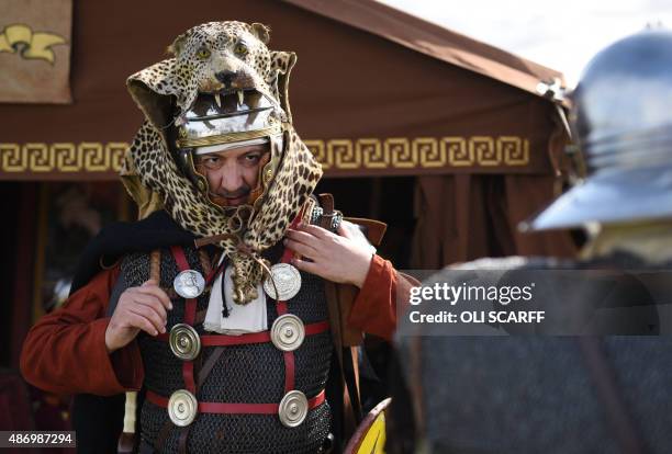 Reenactors portraying soldiers from the Imperial Roman Army prepare for a mock battle with Caledonian barbarians during English Heritage's history...