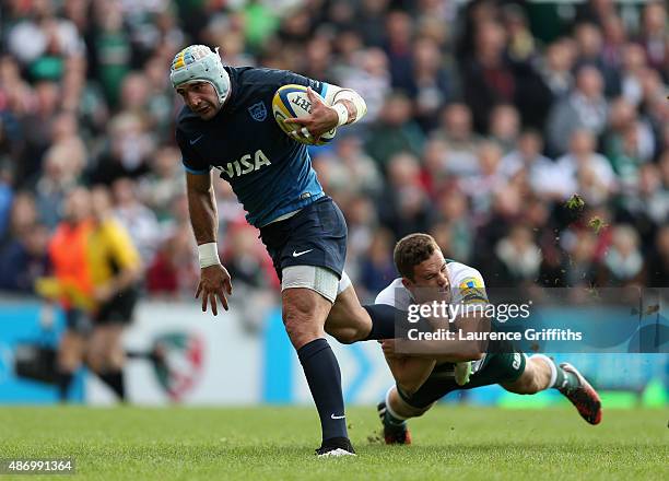 Juan Manuel Leguizamon of Argentina is tackled by George Worth of Leicester Tigers during the Testimonial Challenge match between Leicester Tigers...