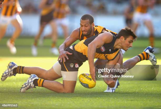 Sam Lloyd of the Tigers is tackled by Josh Gibson of the Hawks during the round six AFL match between the Richmond Tiges and the Hawthorn Hawks at...