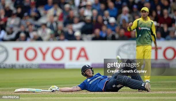 Ben Stokes of England is lies on the ground after avoiding a ball thrown by Mitchell Starc of Australia he was given out for disrupting the field for...