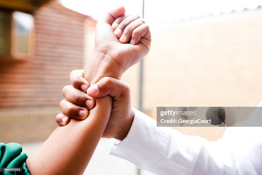 School boy grabs girls arm