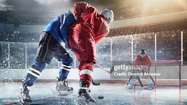 ice hockey players in action - hockey player on ice stock pictures, royalty-free photos & images