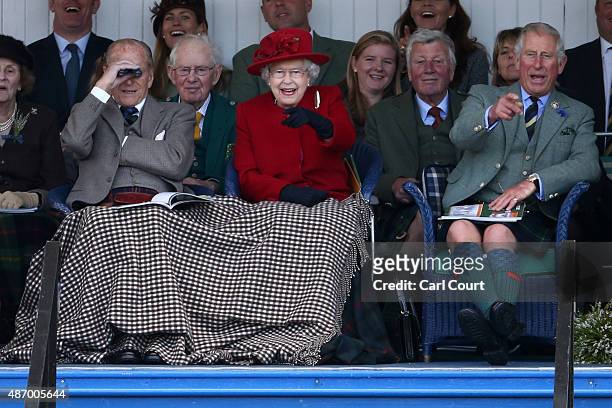 Queen Elizabeth II , Prince Philip, Duke of Edinburgh and Prince Charles, Prince of Wales watch competitors at the Braemar Gathering on September 5,...
