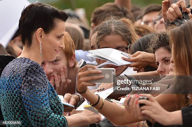 French actress Juliette Binoche signs autographs as she arrives for the screening of the movie "L'attesa" presented in competition at the 72nd Venice...
