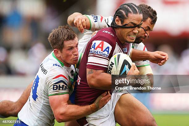 Steve Matai of the Sea Eagles is tackled by the Raiders defence during the round 8 NRL match between the Manly-Warringah Sea Eagles and the Canberra...