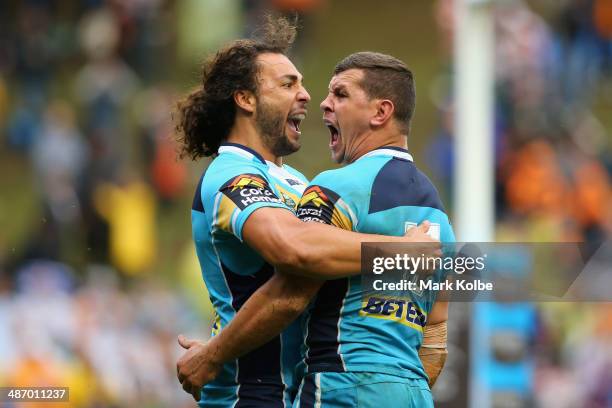 Ryan James of the Titans congratulates Greg Bird of the Titans as he celebrates scoring a try during the round 8 NRL match between the Wests Tigers...