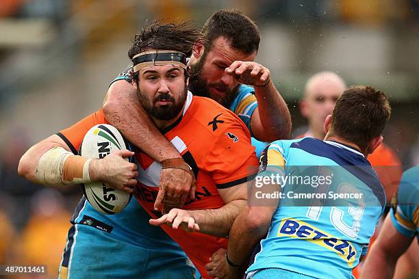 Aaron Woods of the Tigers is tackled during the round 8 NRL match between the Wests Tigers and the Gold Coast Titans at Leichhardt Oval on April 27,...