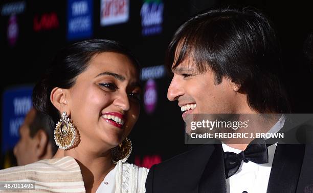 Bollywood actor Vivek Oberoi and his wife Priyanka smile on the green carpet at the Raymond James Stadium on the fourth and final day of the 15th...