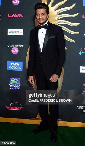 Bollywood actor Riteish Deshmukh poses on the green carpet at the Raymond James Stadium on the fourth and final day of the 15th International Indian...