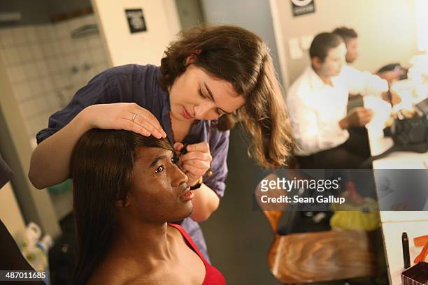 Cast members, including actress Esther Zimmering and "Ona," of "GRENZFAeLLE", a play that stars African refugees and German actresses, prepare for a...