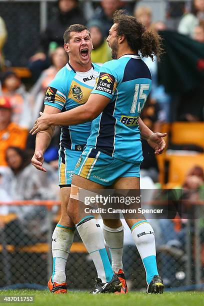 Greg Bird of the Titans celebrates a try with team mate Ryan James during the round 8 NRL match between the Wests Tigers and the Gold Coast Titans at...