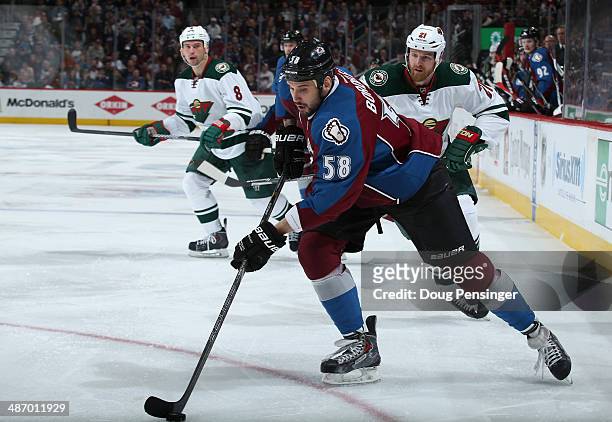 Patrick Bordeleau of the Colorado Avalanche controls the puck against Kyle Brodziak and Cody McCormick of the Minnesota Wild in Game Five of the...