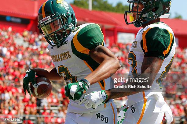 DeAndre Sangster of the Norfolk State Spartans celebrates his touchdown catch with teammate Thomas Stinger against the Rutgers Scarlet Knights during...