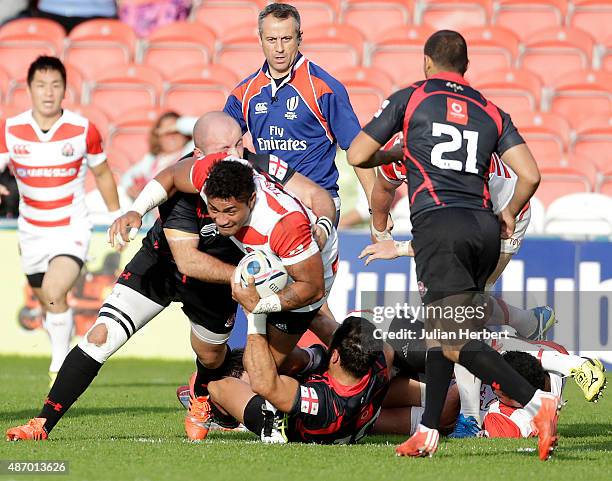 Amanaki Lelei Mafi of Japan is tackled during the Japan v Georgia International Match at The Kingsholm Stadium on September 5, 2015 in Gloucester,...