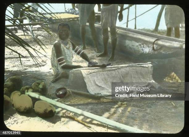 Woman beating Tapa bark cloth, Papua New Guinea, 1912.