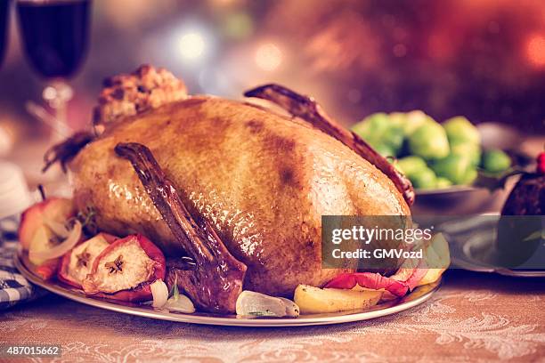 traditional british holiday goose dinner with apples and brussels sprouts - goose meat stock pictures, royalty-free photos & images