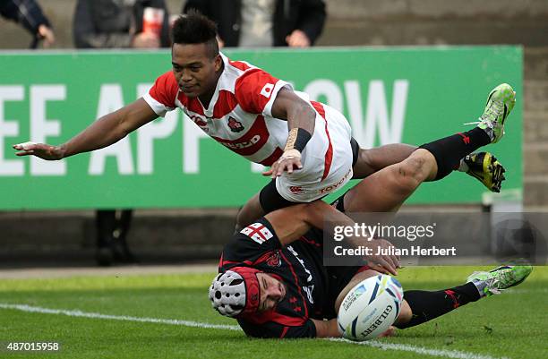 Kotaro Matsushima of Japan and Merab Sharikadze of Georgia chase the ball during the Japan v Georgia International Match at The Kingsholm Stadium on...