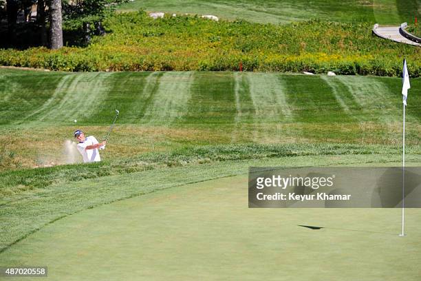 Jason Dufner hits out of a greenside bunker on the 11th hole during the second round of the Deutsche Bank Championship at TPC Boston on September 5,...