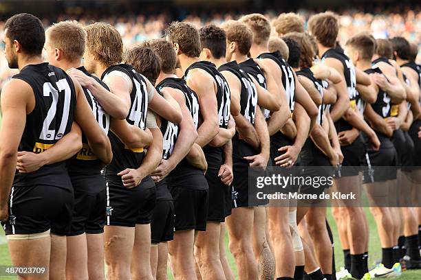 Power players line up before the round six AFL match between Port Adelaide Power and the Geelong Cats at Adelaide Oval on April 27, 2014 in Adelaide,...