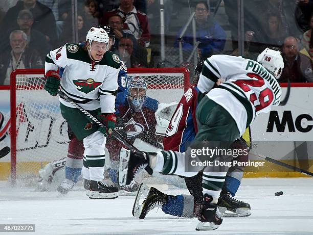 Jason Pominville of the Minnesota Wild takes a shot against Nathan MacKinnon, Andre Benoit and goalie Semyon Varlamov of the Colorado Avalanche as...