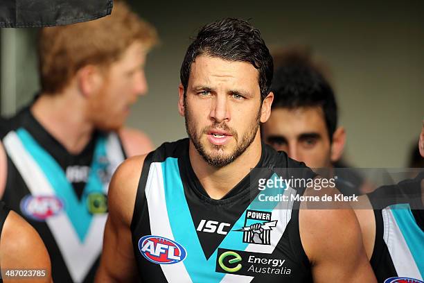 Travis Boak of the Power leads his team onto the ground before the round six AFL match between Port Adelaide Power and the Geelong Cats at Adelaide...