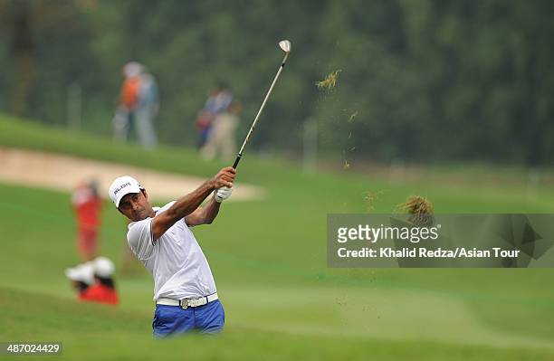 Jyoti Randhawa of India plays a shot during round four of the CIMB Niaga Indonesian Masters at Royale Jakarta Golf Club on April 27, 2014 in Jakarta,...