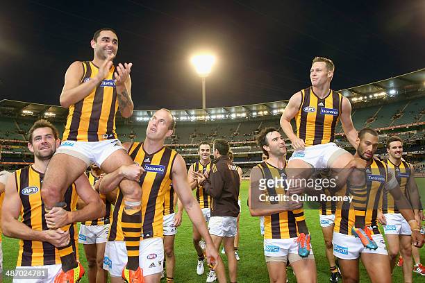 Shaun Burgoyne and Sam Mitchell of the Hawks are chaired off the field in their 250th games during the round six AFL match between the Richmond Tiges...