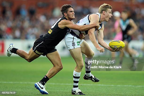 Chad Wingard of the Power tackles George Horlin-Smith of the Cats during the round six AFL match between Port Adelaide Power and the Geelong Cats at...