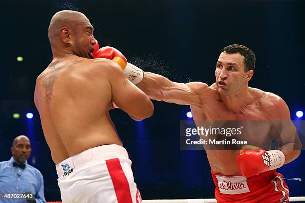 Wladimir Klitschko of Ukraine exchanges punches with Alex Leapai of Australia during their WBO, WBA, IBF and IBO heavy weight title fight between...