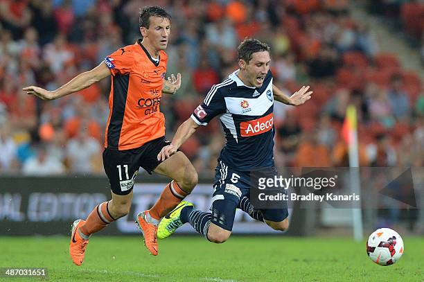 Liam Miller of the Roar is penalised for this challenge on Mark Milligan of the Victory during the A-League Semi Final match between the Brisbane...