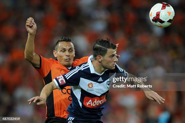 James Troisi of the Victory competes for the ball with Jade North of the Roar during the A-League Semi Final match between the Brisbane Roar and...